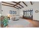 Large main bedroom with ceiling beams, a window seat and tiled floors at 3756 N Rock Wren Ct, Buckeye, AZ 85396