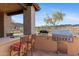 Outdoor kitchen area with built-in grill and seating, perfect for entertaining at 3756 N Rock Wren Ct, Buckeye, AZ 85396