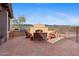 Expansive patio featuring outdoor fireplace, seating, and BBQ area for relaxing and entertaining at 3756 N Rock Wren Ct, Buckeye, AZ 85396