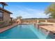 Beautiful pool and spa area surrounded by desert landscape and inviting outdoor seating at 3756 N Rock Wren Ct, Buckeye, AZ 85396