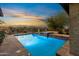 Sparkling backyard pool and spa area with beautiful desert surroundings at 3756 N Rock Wren Ct, Buckeye, AZ 85396