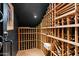 View of the dark wine cellar with wooden storage racks and tile floors at 3756 N Rock Wren Ct, Buckeye, AZ 85396