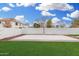 Backyard featuring a concrete basketball court and a well-manicured lawn area, ideal for sports enthusiasts at 3760 E Cotton Ct, Gilbert, AZ 85234