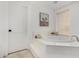 Modern bathroom featuring soaking tub, picture window and neutral color palette at 3760 E Cotton Ct, Gilbert, AZ 85234