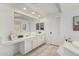 Bright bathroom featuring double vanity with modern fixtures and a large mirror at 3760 E Cotton Ct, Gilbert, AZ 85234