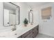 Modern bathroom featuring a double vanity, mosaic floor tile, and brushed gold fixtures at 3760 E Cotton Ct, Gilbert, AZ 85234