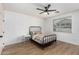 Minimalist bedroom with wood-look flooring, a metal bed frame, and a sleek, modern nightstand at 3760 E Cotton Ct, Gilbert, AZ 85234