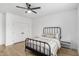 Minimalist bedroom with wood-look flooring, a metal bed frame, and a sleek, modern nightstand at 3760 E Cotton Ct, Gilbert, AZ 85234