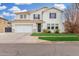 Traditional two-story home featuring a manicured lawn, a two-car garage and a welcoming entrance at 3760 E Cotton Ct, Gilbert, AZ 85234