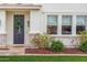 Home's front door with a green wreath, stylish sconces, and decorative stone accents at 3760 E Cotton Ct, Gilbert, AZ 85234