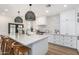 Bright kitchen with white cabinetry, marble countertops, and eat-in island at 3760 E Cotton Ct, Gilbert, AZ 85234