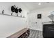 Functional mudroom area with coat hooks, shoe storage, a bench and a convenient washer and dryer at 3760 E Cotton Ct, Gilbert, AZ 85234