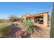 Backyard with a covered patio, desert landscaping, and scenic views at 41225 N River Bend Rd, Phoenix, AZ 85086