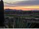 View from the backyard showing a beautiful desert landscape, golf course, and mountains in the distance at 41225 N River Bend Rd, Phoenix, AZ 85086