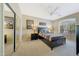 Bedroom with a black bed frame, ceiling fan, and mirrored closet doors at 41225 N River Bend Rd, Phoenix, AZ 85086