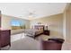 This main bedroom with an upholstered bed offers a calming retreat and amazing views at 41225 N River Bend Rd, Phoenix, AZ 85086