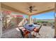 Outdoor covered patio features tile flooring, a ceiling fan, desert views, a grill and outdoor seating at 41225 N River Bend Rd, Phoenix, AZ 85086