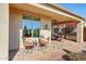 This outdoor covered patio features desert views and landscaping, tile flooring, a grill and outdoor seating at 41225 N River Bend Rd, Phoenix, AZ 85086