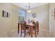 Cozy dining area features a wooden table set, stylish lighting, and a bright window view at 41225 N River Bend Rd, Phoenix, AZ 85086