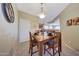 Dining area with a wooden table and tile floors situated near the kitchen in an open concept layout at 41225 N River Bend Rd, Phoenix, AZ 85086