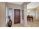 View of foyer leading to the dining room, with tile floors, a front door, and decorative vase at 41225 N River Bend Rd, Phoenix, AZ 85086