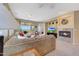 Bright living room features a fireplace, tile floor, and sliding glass doors to an outdoor living area at 41225 N River Bend Rd, Phoenix, AZ 85086