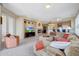 Open concept living room with tile floor, fireplace, and adjacent kitchen offers seamless entertaining at 41225 N River Bend Rd, Phoenix, AZ 85086