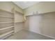 Walk-in closet with multiple shelves and hanging rods to organize your wardrobe at 41225 N River Bend Rd, Phoenix, AZ 85086