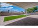 Backyard featuring artificial turf, brick pavers, concrete block wall, gravel and outdoor space for relaxation or entertaining at 4215 W Villa Rita Dr, Glendale, AZ 85308