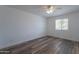 Cozy bedroom with a ceiling fan, modern flooring, and a bright window at 4215 W Villa Rita Dr, Glendale, AZ 85308