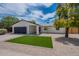 Single-story home featuring a manicured lawn and a convenient two-car garage at 4215 W Villa Rita Dr, Glendale, AZ 85308