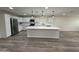 Modern kitchen with white cabinetry, a stainless steel refrigerator, and a large island at 4215 W Villa Rita Dr, Glendale, AZ 85308