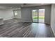 Open-concept living room with stylish flooring and sliding glass doors to the patio at 4215 W Villa Rita Dr, Glendale, AZ 85308