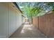 Side yard showcases a low-maintenance landscape with gravel, trees, and a privacy wall at 4215 W Villa Rita Dr, Glendale, AZ 85308