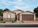 Charming single-story home with a two-car garage, neutral stucco, stone accents, and desert landscaping at 4248 W Hannah St, San Tan Valley, AZ 85144