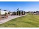 Community playground featuring a picnic pavilion, playground equipment, seating area, and walking paths at 4248 W Hannah St, San Tan Valley, AZ 85144