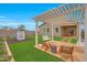 The backyard is perfect for entertaining with a custom pergola, swing, and playhouse at 44323 N 43Rd Dr, Phoenix, AZ 85087