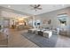 Inviting living room with a cozy gray sofa, rug and seamless transition into the open kitchen at 44323 N 43Rd Dr, Phoenix, AZ 85087