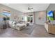 Comfortable living room with neutral tones, stylish furniture, and a sliding glass door to the backyard at 44323 N 43Rd Dr, Phoenix, AZ 85087