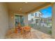 Comfortable outdoor seating area on the patio with an outdoor dining table and decorative lanterns at 44323 N 43Rd Dr, Phoenix, AZ 85087