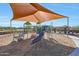 Community playground with a sunshade that features slides and climbing structures at 44323 N 43Rd Dr, Phoenix, AZ 85087