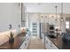 Bright, open kitchen featuring sleek white cabinetry, black countertops, and stainless steel appliances at 44409 N 43Rd Dr, Phoenix, AZ 85087