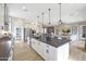 Spacious kitchen featuring white cabinets, stainless steel appliances, and a large center island at 44409 N 43Rd Dr, Phoenix, AZ 85087