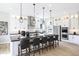 Modern kitchen featuring an expansive island with barstool seating, pendant lights, and sleek cabinetry at 44409 N 43Rd Dr, Phoenix, AZ 85087