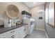 Bright and spacious laundry room with front-loading washer and dryer and ample counter space at 44409 N 43Rd Dr, Phoenix, AZ 85087