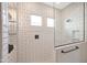 Bright tile shower featuring glass door, overhead shower and decorative inset windows at 44409 N 43Rd Dr, Phoenix, AZ 85087