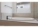 Bright bathroom features a modern soaking tub and a large window for natural light at 44717 N 44Th Dr, Phoenix, AZ 85087