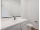 Powder room featuring a modern sink, vanity, and black fixtures for an elegant touch at 44717 N 44Th Dr, Phoenix, AZ 85087