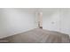 Neutral bedroom featuring plush carpet, a walk-in closet, and modern doors at 44717 N 44Th Dr, Phoenix, AZ 85087