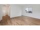 A bright bedroom with wood-look tile flooring and a view into the hallway at 44717 N 44Th Dr, Phoenix, AZ 85087